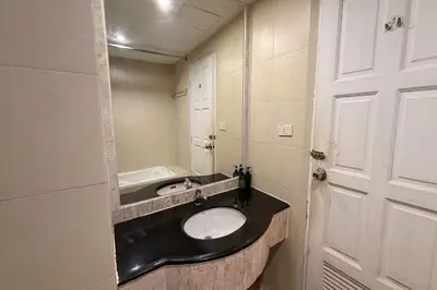 a bathroom with a sink and a mirror at The Grand Imperial in Ban Song Hong