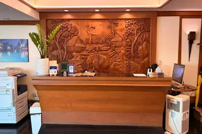 an office with a reception desk with a wooden wall at The Grand Imperial in Ban Song Hong