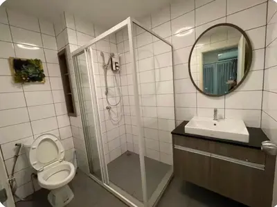 a bathroom with a shower and a toilet and a sink at Chapter One Eco Ratchada-HuaiKhwang in Bangkok
