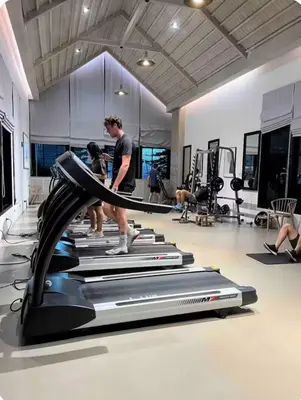 two people on a treadmill in a gym at Chapter One Eco Ratchada-HuaiKhwang in Bangkok