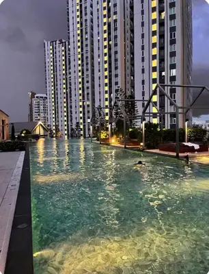 a swimming pool in front of some tall buildings at Chapter One Eco Ratchada-HuaiKhwang in Bangkok