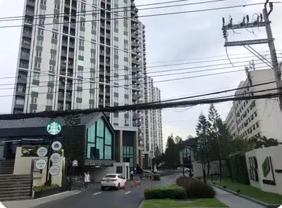 a city street with a tall building in the background at Chapter One Eco Ratchada-HuaiKhwang in Bangkok