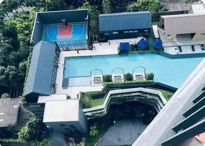 an aerial view of a house with a swimming pool at Chapter One Eco Ratchada-HuaiKhwang in Bangkok