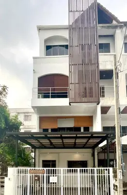 a white building with a balcony with a fence at Impact Arena & DMK - 4BR 12pax Home 55