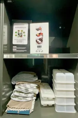 a shelf in a refrigerator filled with towels and papers at Impact Arena & DMK - 4BR 12pax Home 55