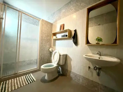 a bathroom with a toilet and a sink and a mirror at Impact Arena & DMK - 4BR 12pax Home 55