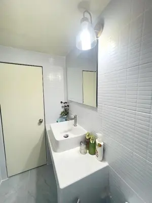 a white bathroom with a sink and a mirror at Lazy Ma-fia C3 Andy in Ban Song Hong