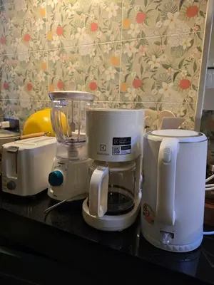 a counter with three appliances sitting on a table at Carl and Ellie Home in Bangkok