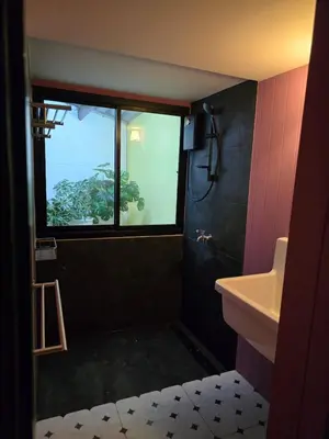 a bathroom with a sink and a window at Carl and Ellie Home in Bangkok