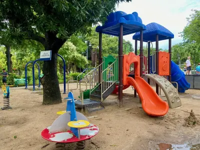 a playground in a park with a slide and a slideintend at Carl and Ellie Home in Bangkok