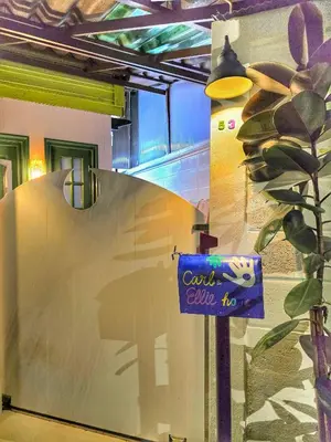 a sign on a wall in a room at Carl and Ellie Home in Bangkok