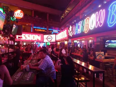 a group of people in a bar with neon signs at XX Oh My Nap BTS NANA in Makkasan