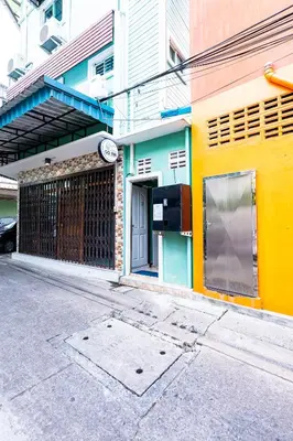 a building with a clock on the side of it at xxGO INN The Giant Swing - โกอินน เสาชิงช้า in Bangkok