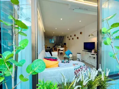 a room with a bed with colorful pillows on it at MRT-Accessible & Delightful Family Hub! in Bangkok