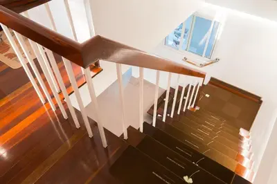 a staircase with a wooden railing and a window at MRT-Accessible & Delightful Family Hub! in Bangkok