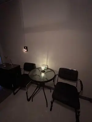 a dining room with a glass table and chairs at Munchies Bed & Breakfast in Bangkok