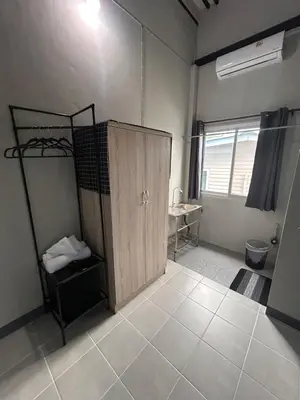 a bathroom with a wooden door in a room at Munchies Bed & Breakfast in Bangkok