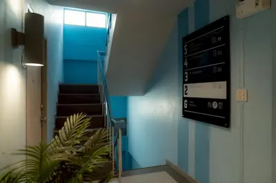 a stairway with a sign on the wall of a building at Monument Stay in Bangkok