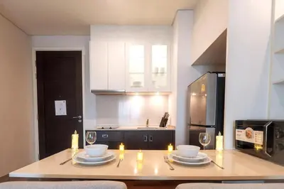 a kitchen with a table with plates and candles on it at Thong Lor Luxury condo with Swimming Pool, Fast Wifi in Sathani Khlong Tan