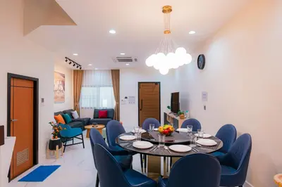 a dining room with a table and blue chairs at EXCLUSIVE SUKHUMVIT RESIDENCE, 3 Min BTS, Thonglor, 20 Guests in Bangkok