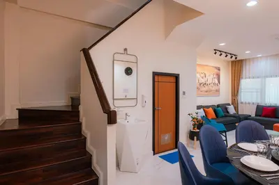 a room with a dining table and a living room at EXCLUSIVE SUKHUMVIT RESIDENCE, 3 Min BTS, Thonglor, 20 Guests in Bangkok