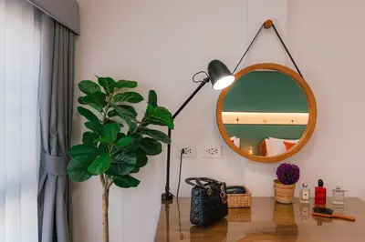 a room with a mirror and a table with a plant at EXCLUSIVE SUKHUMVIT RESIDENCE, 3 Min BTS, Thonglor, 20 Guests in Bangkok