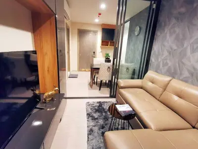 a living room with a couch and a table at Life asoke rama 9 in Bangkok