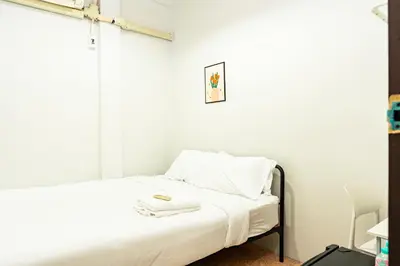 a small bedroom with a bed with white sheets at xx BAO The Giant Swing - เสาชิงช้า ศาลเจ้าพ่อเสือ 1 in Bangkok