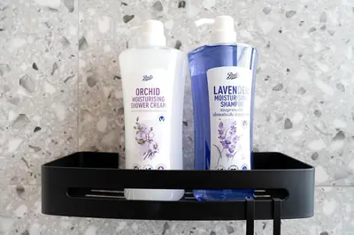 a black shelf with two bottles of hair products on it at Townhouse at Sathu Pradit road in Bangkok