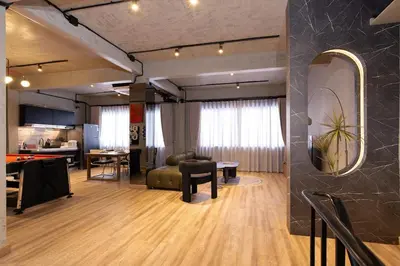 a living room with a couch and a table at Townhouse at Sathu Pradit road in Bangkok