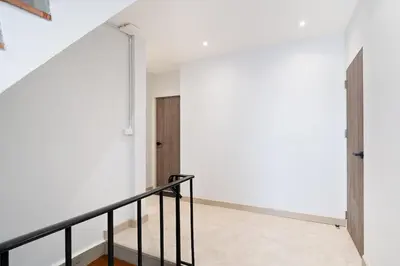 an empty room with a staircase and a door at Townhouse at Sathu Pradit road in Bangkok
