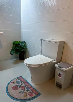 a bathroom with a toilet and a rug at Panoramic River View Residence in Bangkok