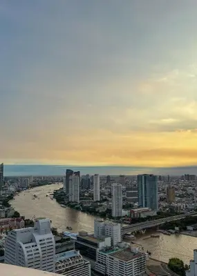 a view of a river in a city with buildings at Panoramic River View Residence in Bangkok