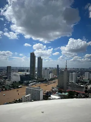 a view of a city with a beach and buildings at Panoramic River View Residence in Bangkok