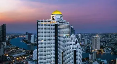 a tall building with a gold dome on top of it at Panoramic River View Residence in Bangkok