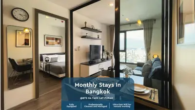 a room with a view of a room with a mirror at Near BTS - High-Floor - Rooftop Pool - Sontana in Bangkok