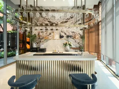 a lobby with a bar with two blue stools at Near BTS - High-Floor - Rooftop Pool - Sontana in Bangkok