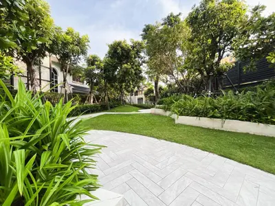 a walkway in a yard with plants at Near BTS - High-Floor - Rooftop Pool - Sontana in Bangkok