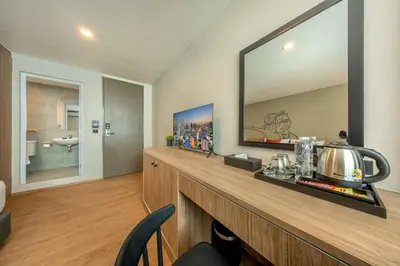 a room with a counter with a large mirror at Ralph Poshtel Sukhumvit in Bangkok
