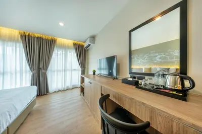 a hotel room with a large flat screen tv at Ralph Poshtel Sukhumvit in Bangkok