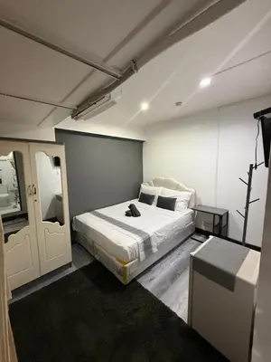 a bedroom with a large bed in a room at Ree House- Sukhumvit 23 in Bangkok