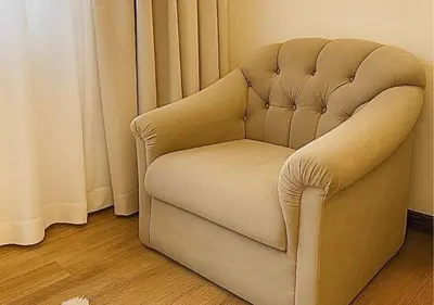 a chair sitting in a room next to a curtain at Solumie Boutique Hotel in Bangkok