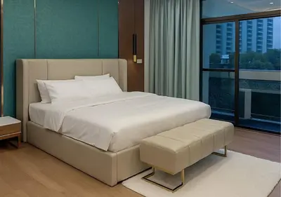 a bedroom with a large white bed and a large window at Solumie Boutique Hotel in Bangkok