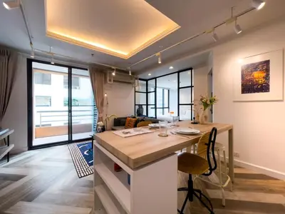 a room with a kitchen with a table and some windows at Prime Chidlom 50sqm l Large Kitchen l Walk to BTS l Wifi in Bangkok