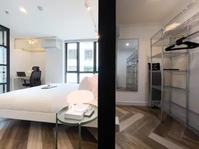 a bedroom with a bed and a glass table at Prime Chidlom 50sqm l Large Kitchen l Walk to BTS l Wifi in Bangkok