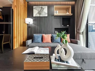 a living room with a couch and a coffee table at Near MRT l Modern 2BR l Pool and Gym l Sontana in Bangkok