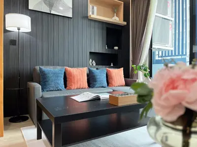 a living room with a couch and a coffee table at Near MRT l Modern 2BR l Pool and Gym l Sontana in Bangkok