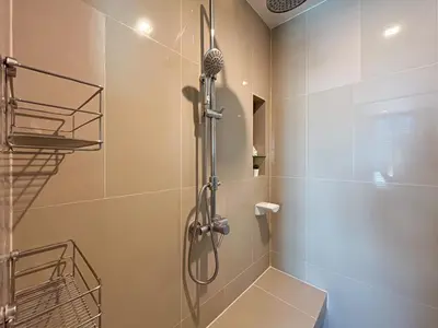 a bathroom with a shower with a shower head at Near MRT l Modern 2BR l Pool and Gym l Sontana in Bangkok