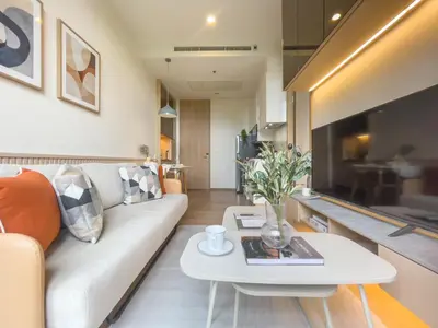 a living room with a white couch and a table at Asoke Luxury High Rise - Steps to BTS and MRT - WiFi in Bangkok