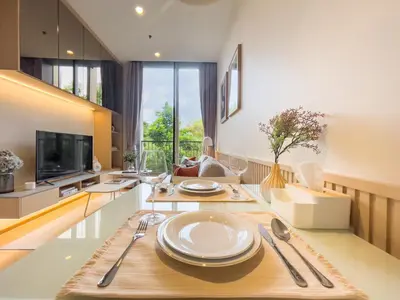 a living room with a table with plates on it at Asoke Luxury High Rise - Steps to BTS and MRT - WiFi in Bangkok